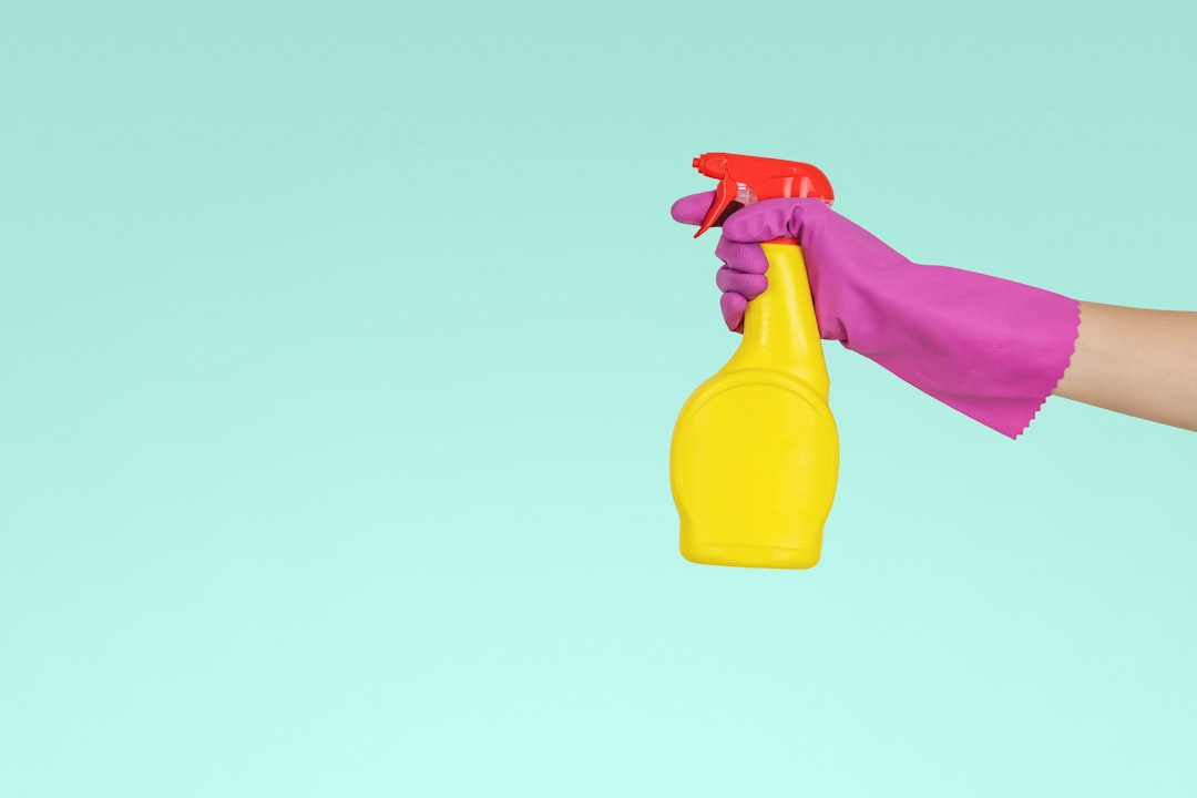 individual-grasping-yellow-plastic-sprayer-zmnefoi3k